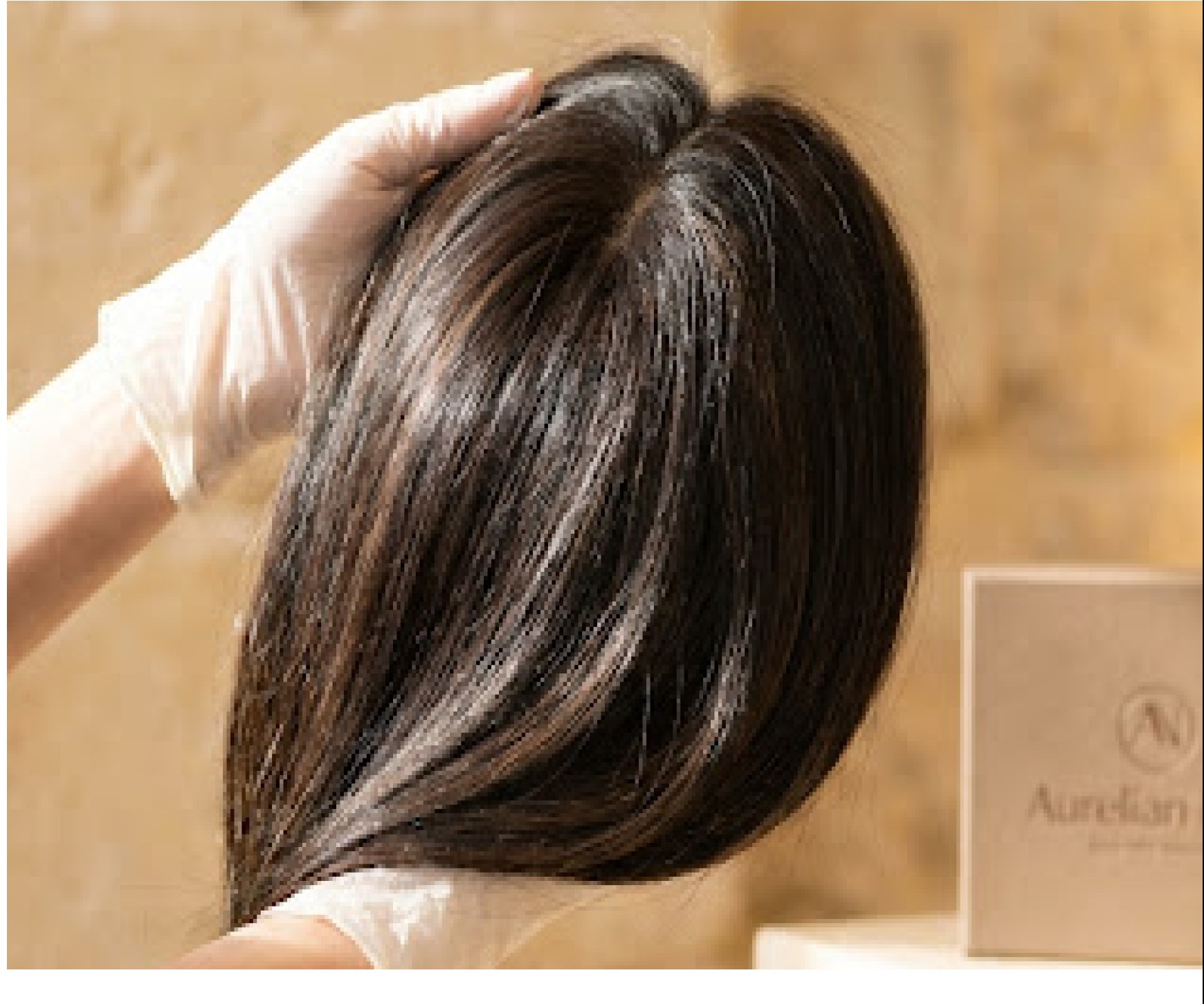 Hands adjusting a custom hair piece