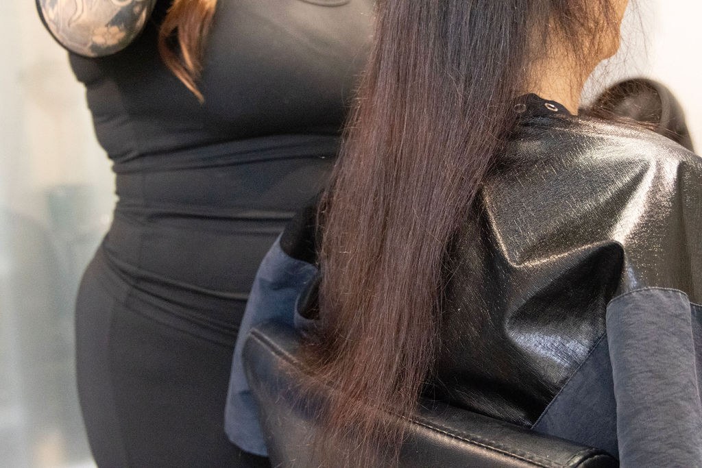 Specialist working on a client's hair extension